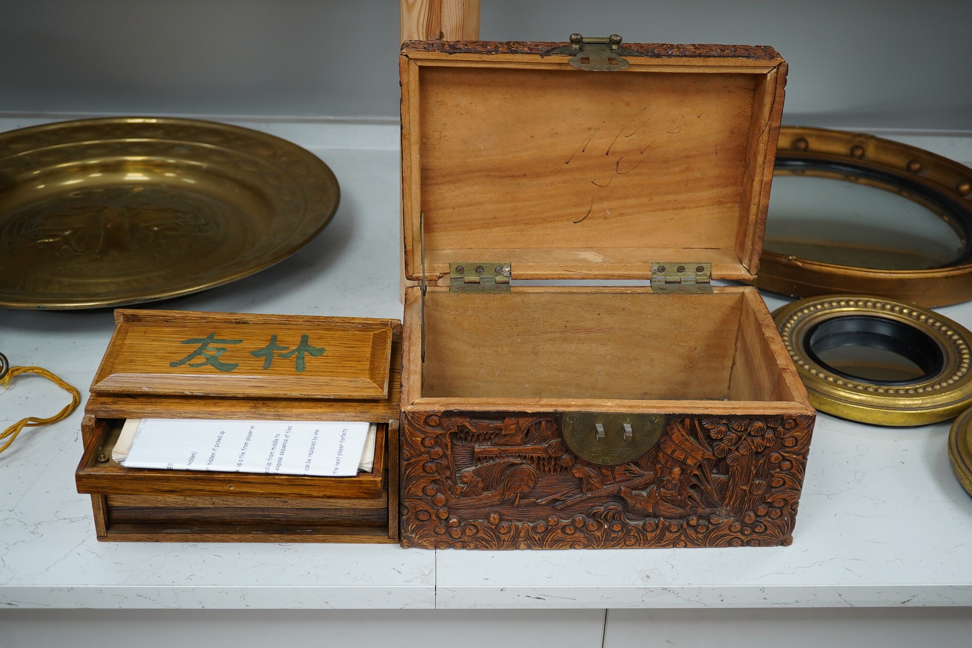 A Chinese carved small camphor box and an oak cased Mahjong set, camphor box 31cm wide x 17cm high. Condition - fair